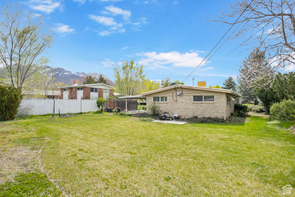 View of yard featuring fence and a mountain view