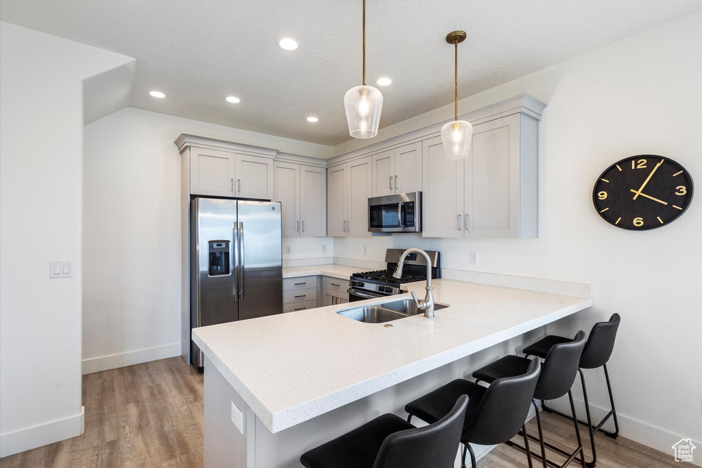 Kitchen featuring a peninsula, baseboards, recessed lighting, and appliances with stainless steel finishes