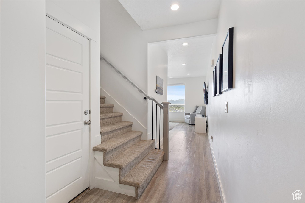 Entryway featuring light wood-type flooring, recessed lighting, and stairs