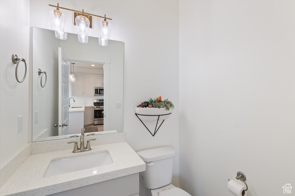 Half bathroom with vanity and toilet