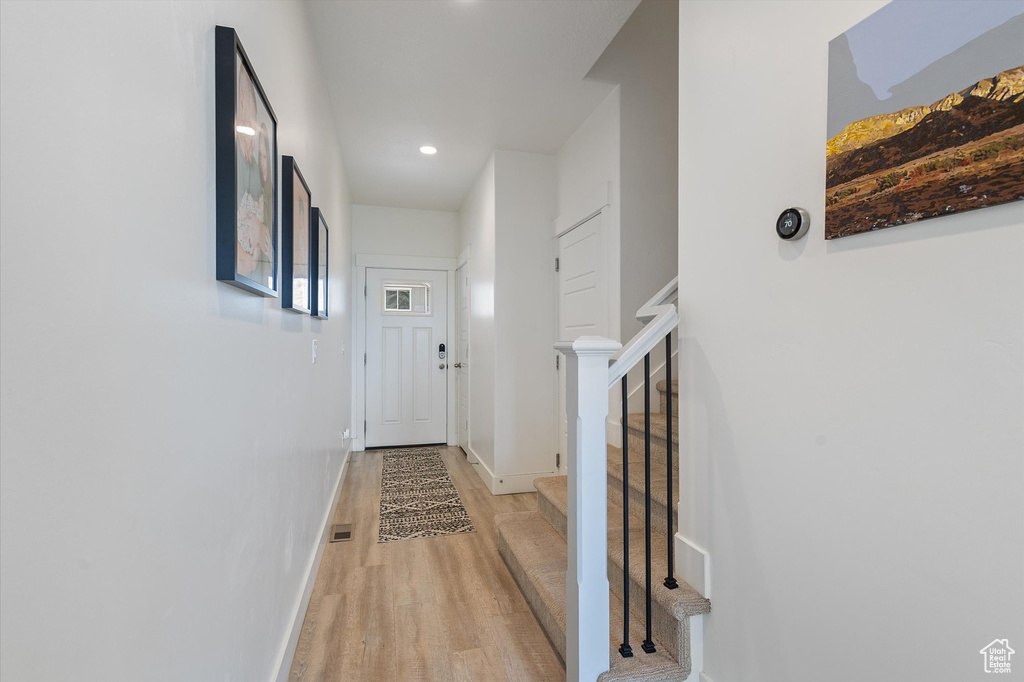 Hall featuring stairway, light wood-style floors, baseboards, visible vents, and recessed lighting