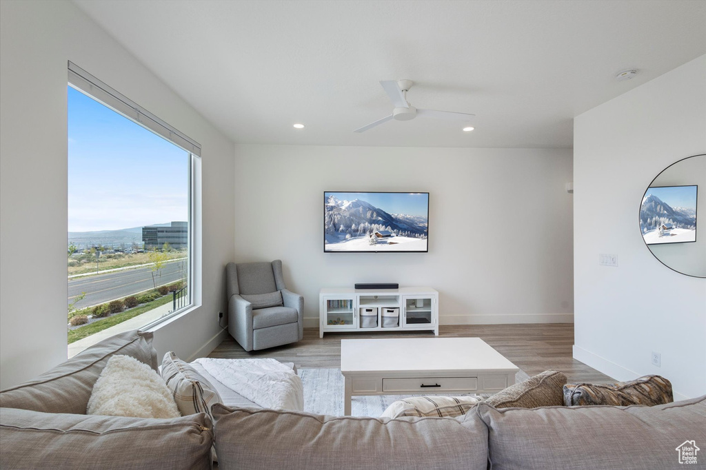 Living room featuring recessed lighting, light wood finished floors, a ceiling fan, and baseboards