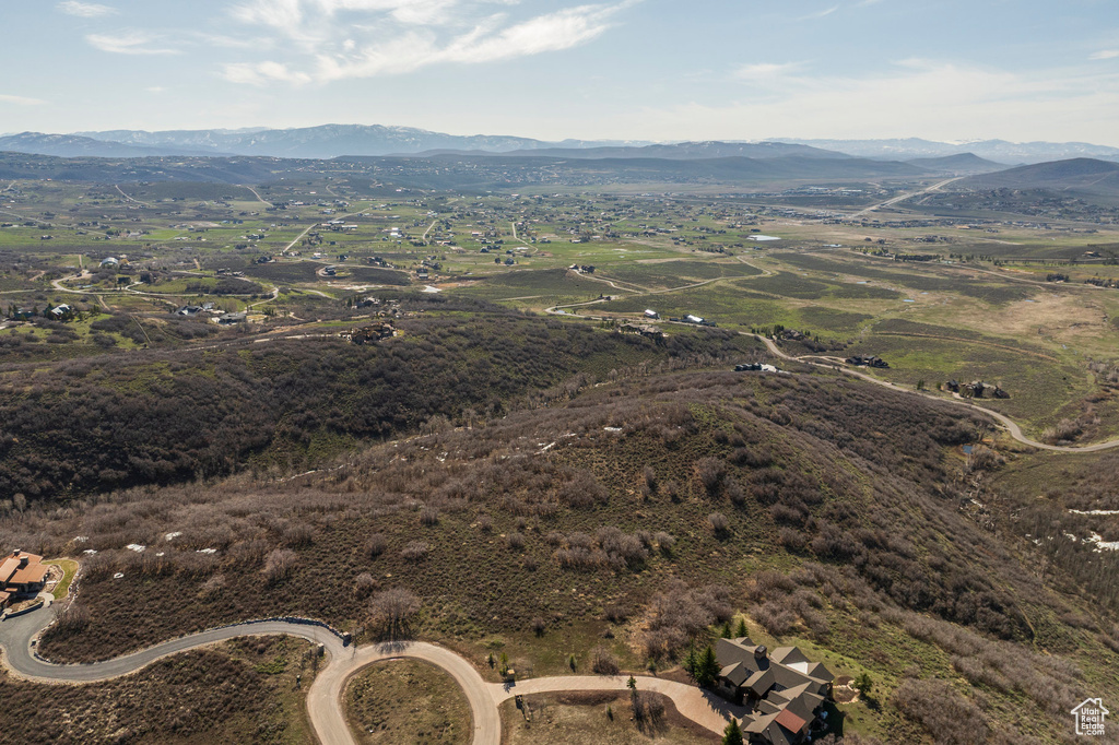 Aerial view of property's location with a mountainous background