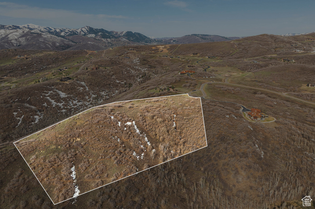 Aerial overview of property's location featuring property parcel outlined and a mountain backdrop
