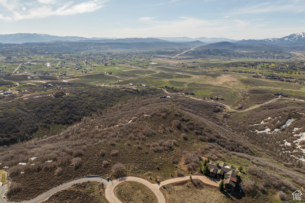 Aerial view of property and surrounding area with a mountainous background