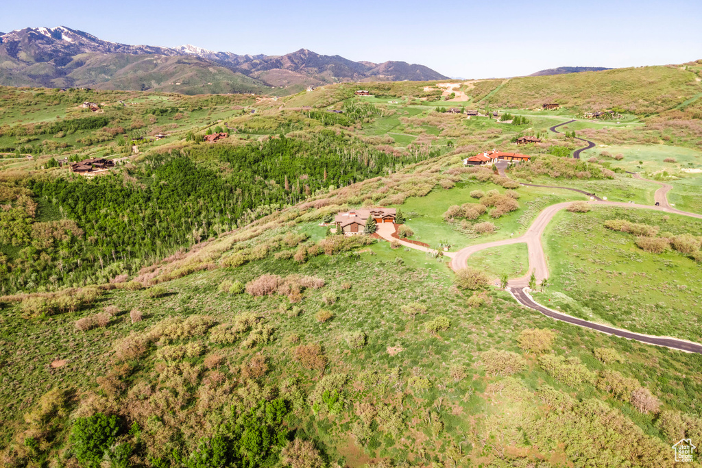 Aerial view of property's location with a mountainous background
