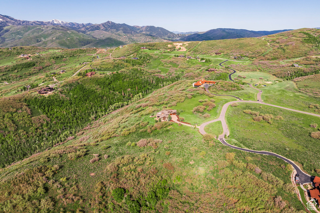 Aerial view of property's location with a mountain backdrop