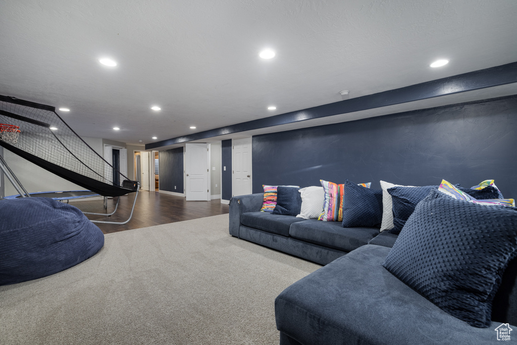 Living room featuring stairway, baseboards, recessed lighting, and wood finished floors