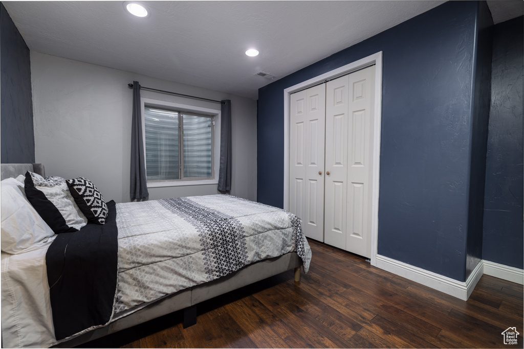 Bedroom featuring wood finished floors, baseboards, a closet, and recessed lighting