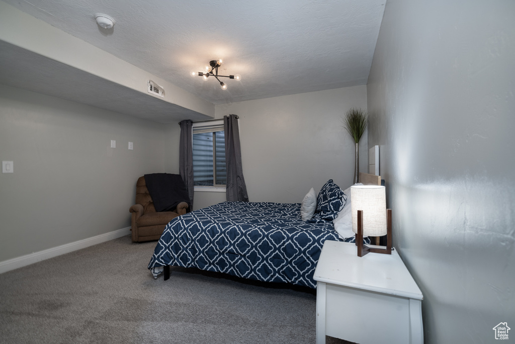 Carpeted bedroom featuring visible vents and baseboards