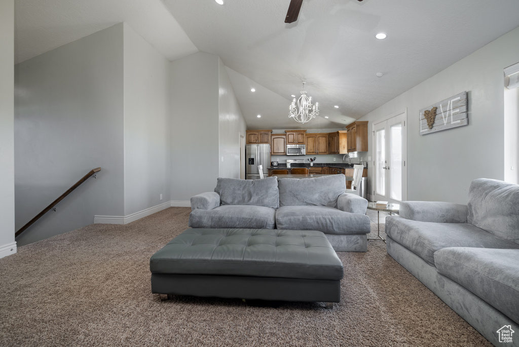 Living area with baseboards, an inviting chandelier, recessed lighting, carpet flooring, and lofted ceiling
