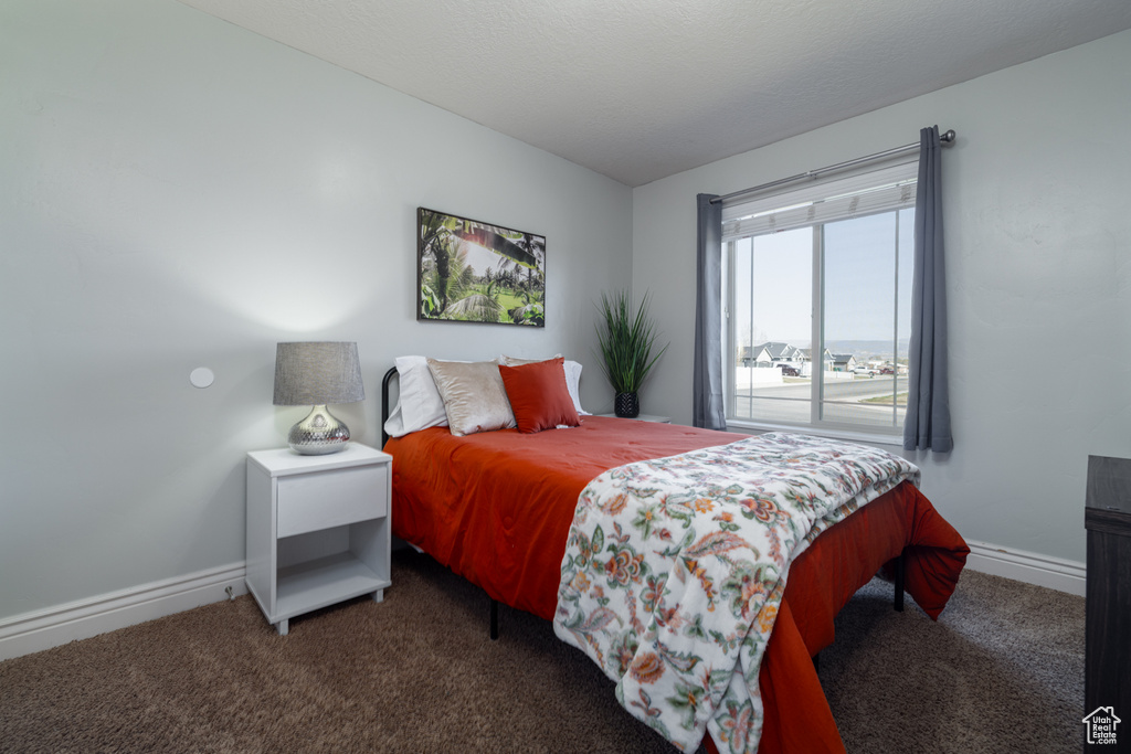 Bedroom featuring carpet floors and baseboards