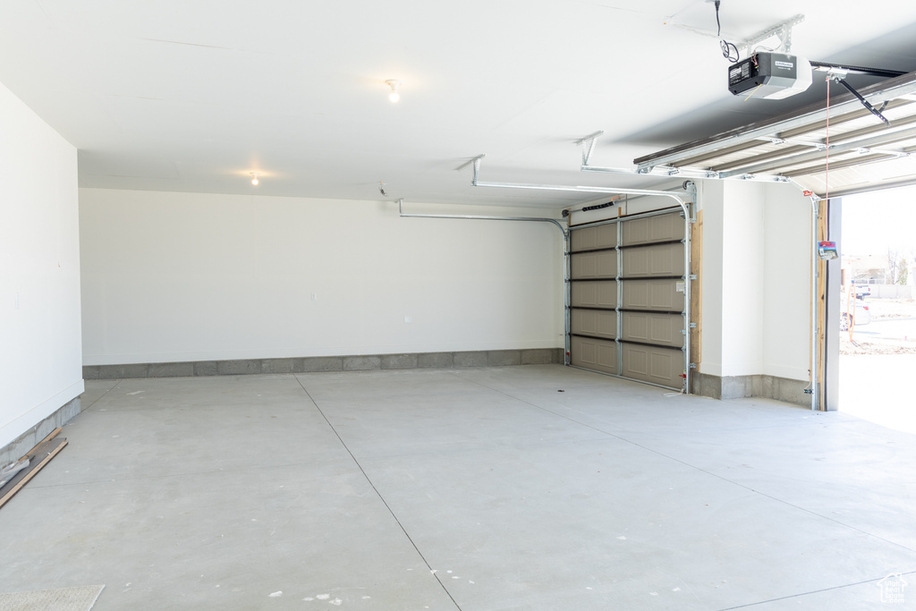 Garage featuring a garage door opener