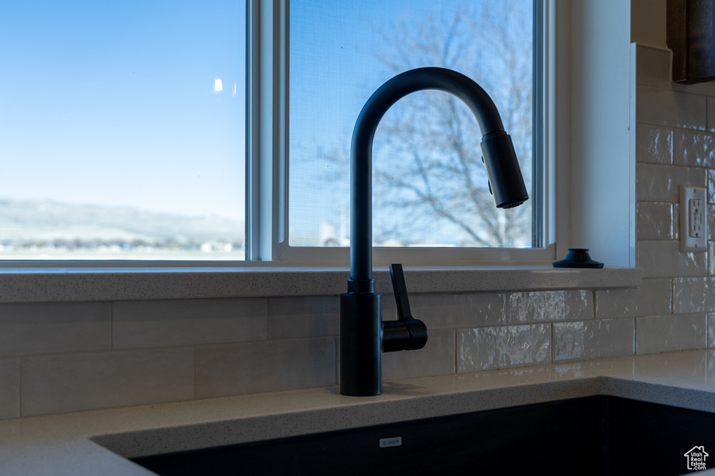 Room details with backsplash and a sink