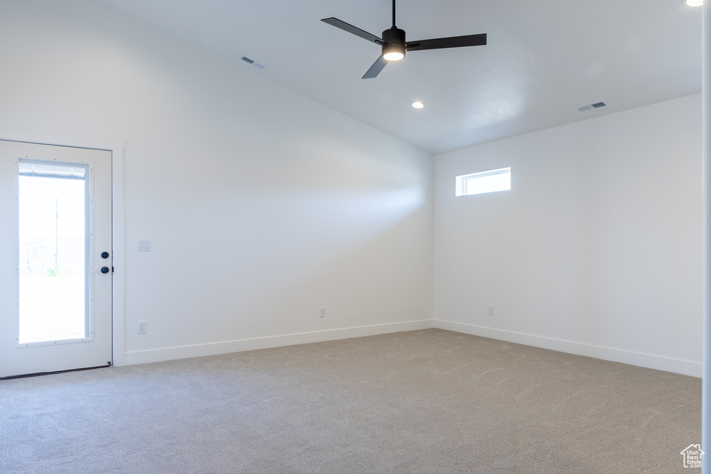 Unfurnished room with high vaulted ceiling, a ceiling fan, light carpet, baseboards, and visible vents