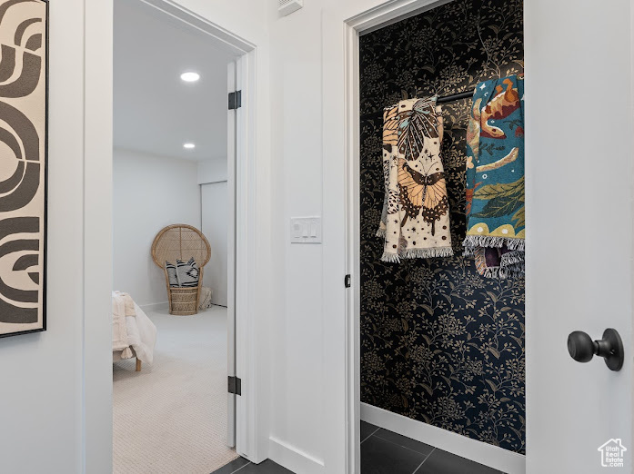 Bathroom with baseboards, wallpapered walls, and recessed lighting