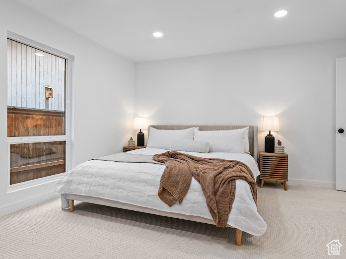 Carpeted bedroom featuring baseboards and recessed lighting