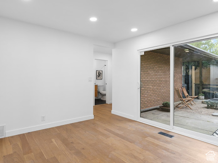 Unfurnished room with visible vents, baseboards, wood finished floors, and recessed lighting