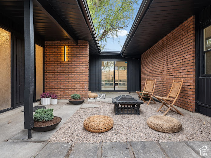 View of patio / terrace with an outdoor fire pit