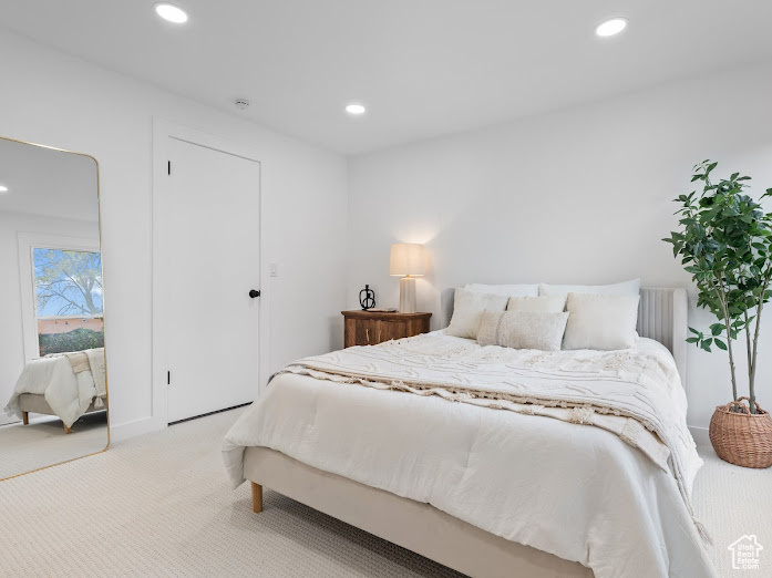 Bedroom with recessed lighting and carpet