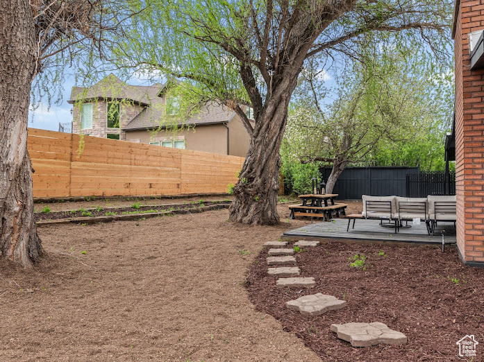 View of yard with fence and a patio