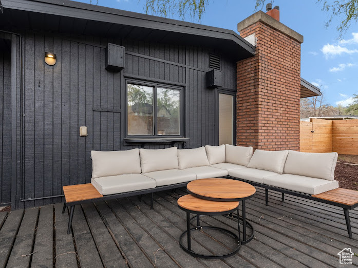 Deck featuring outdoor lounge area and fence