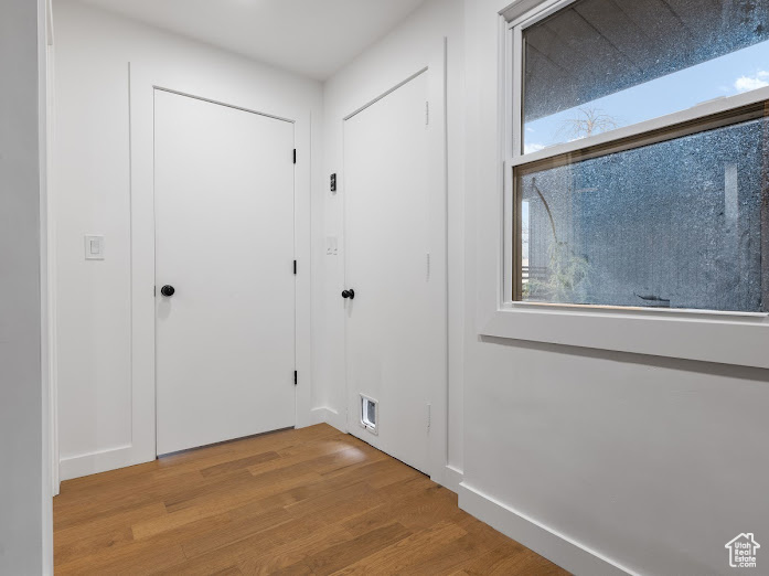 Interior space with baseboards, wood finished floors, visible vents, and plenty of natural light
