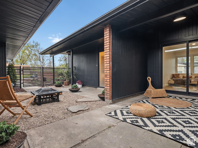 View of patio / terrace featuring fence and an outdoor fire pit