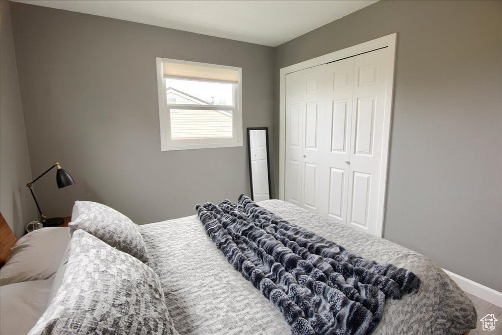 Bedroom featuring baseboards and a closet
