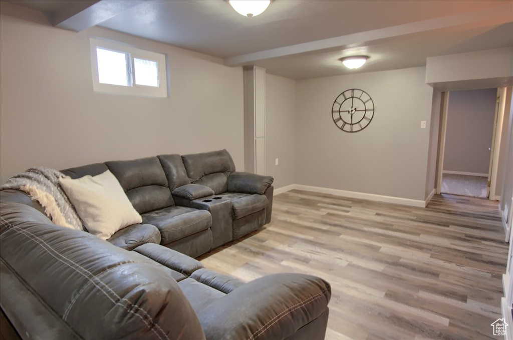 Living area featuring baseboards and light wood-type flooring