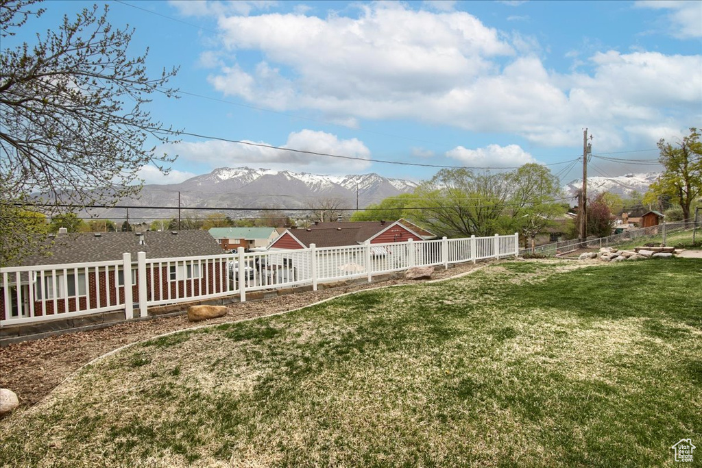View of yard with fence and a mountain view
