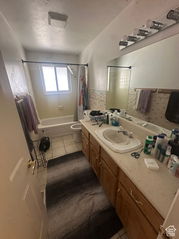 Full bathroom with shower / tub combo, tile patterned floors, vanity, and toilet