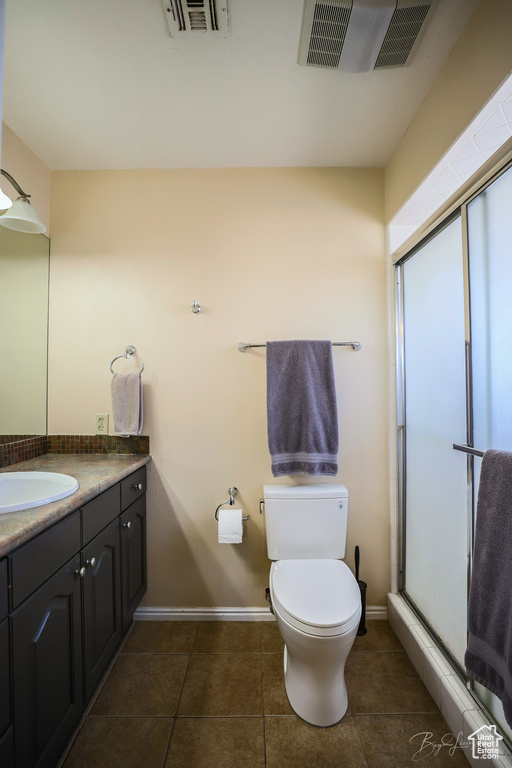 Full bath featuring a shower stall, visible vents, toilet, and vanity