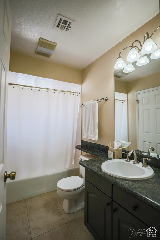 Bathroom featuring vanity, toilet, visible vents, tile patterned flooring, and shower / bath combination with curtain