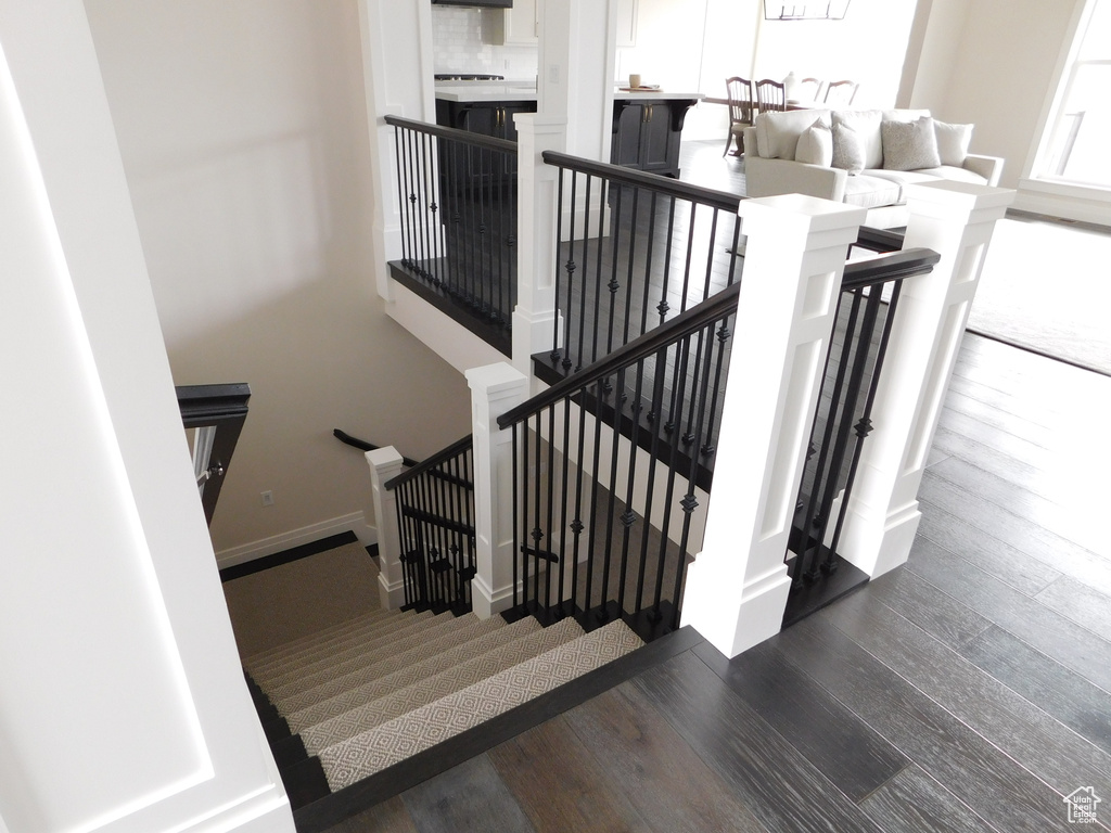 Stairs featuring wood finished floors