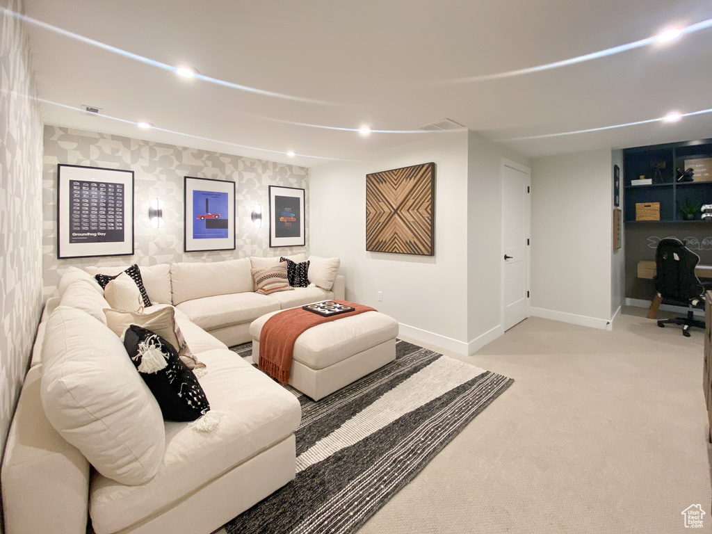 Living room with visible vents, light carpet, baseboards, and recessed lighting