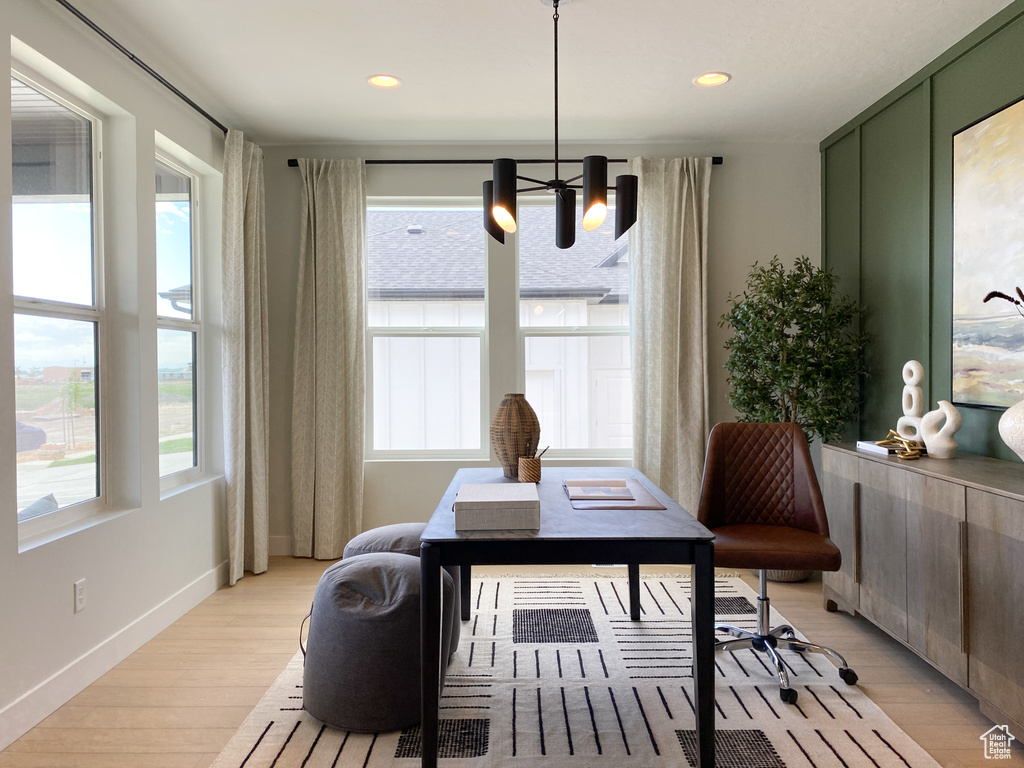 Interior space with baseboards, an inviting chandelier, light wood finished floors, and recessed lighting