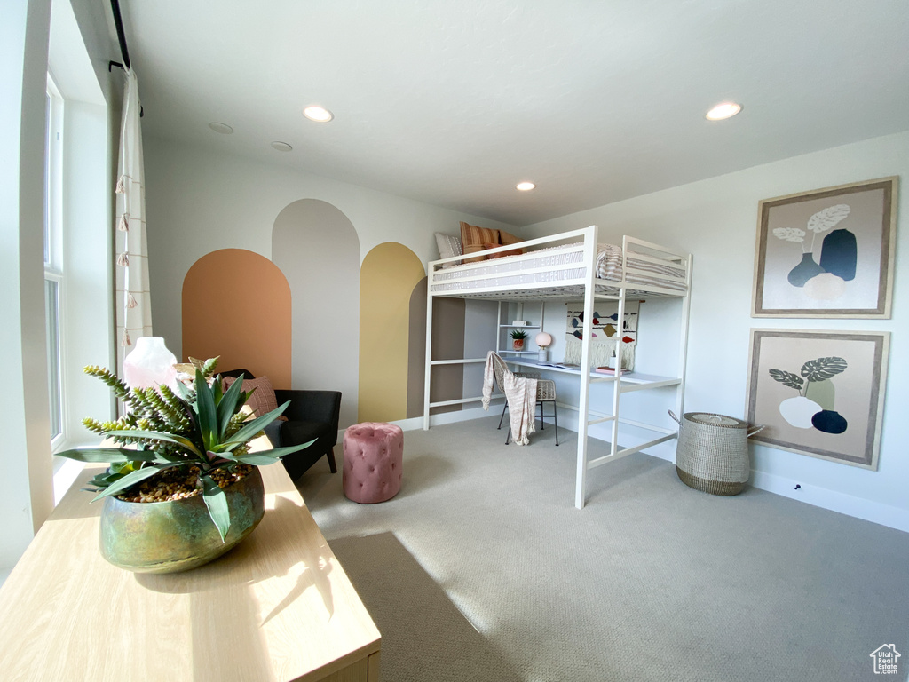 Bedroom featuring recessed lighting, arched walkways, and carpet flooring
