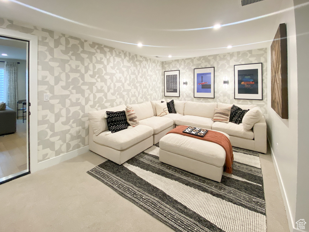Living area with recessed lighting, baseboards, wallpapered walls, and carpet