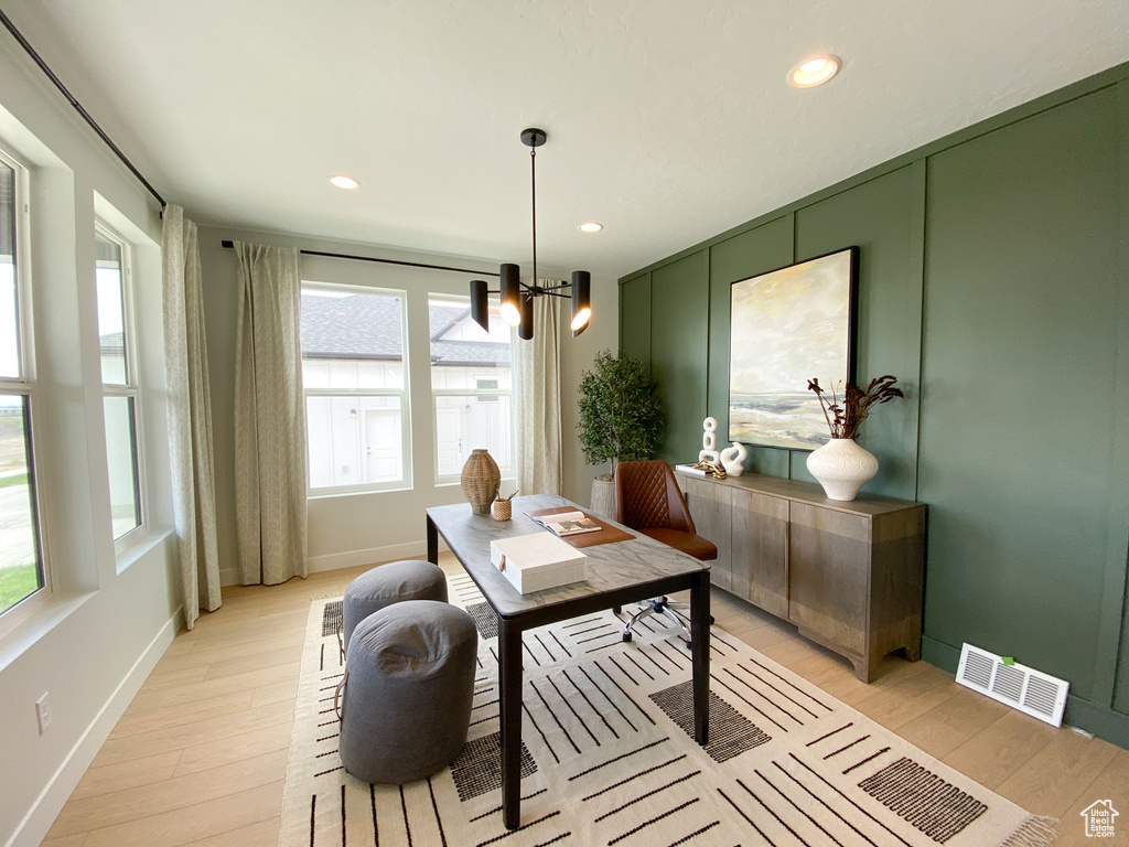 Office featuring light wood finished floors, baseboards, a notable chandelier, visible vents, and recessed lighting