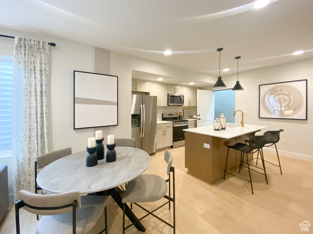 Dining space featuring light wood-type flooring, baseboards, and recessed lighting