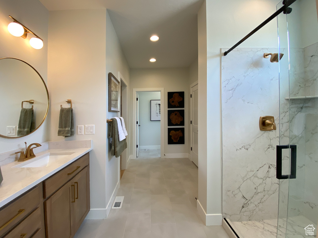 Bathroom with recessed lighting, visible vents, vanity, a marble finish shower, and baseboards