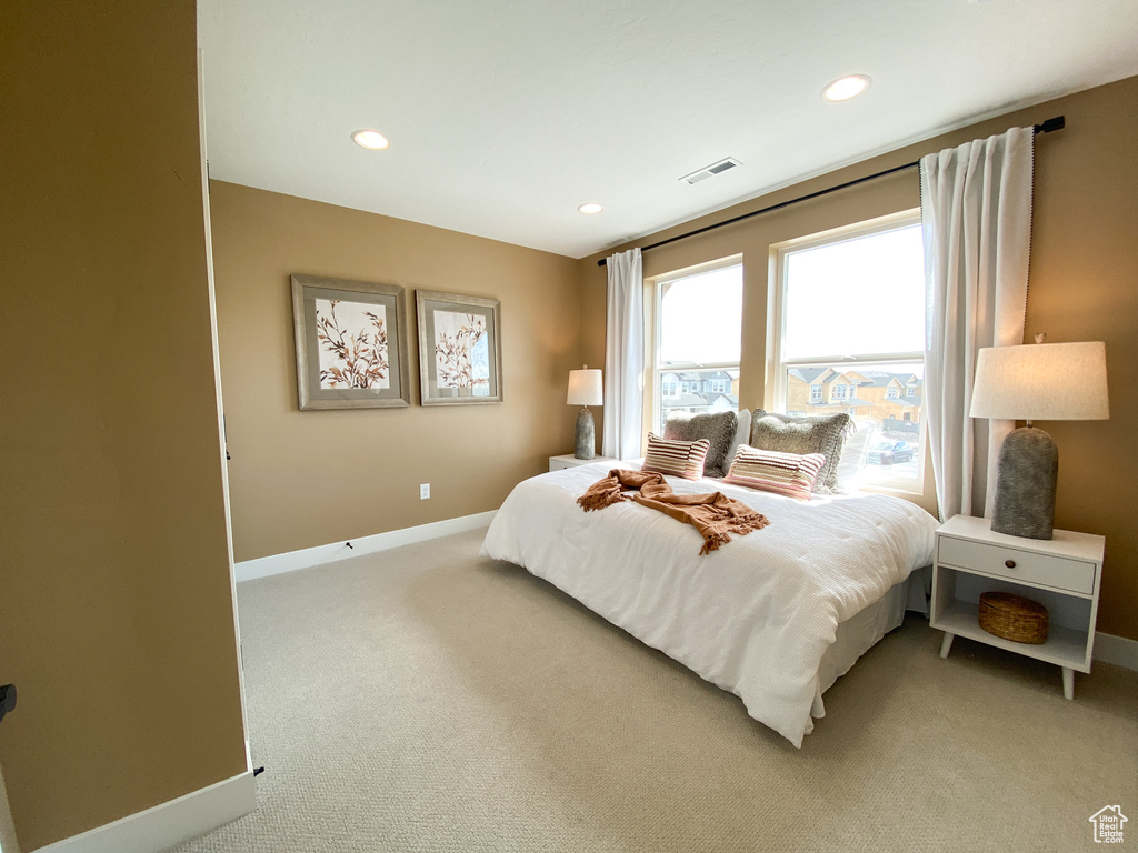 Bedroom with recessed lighting, baseboards, visible vents, and light carpet