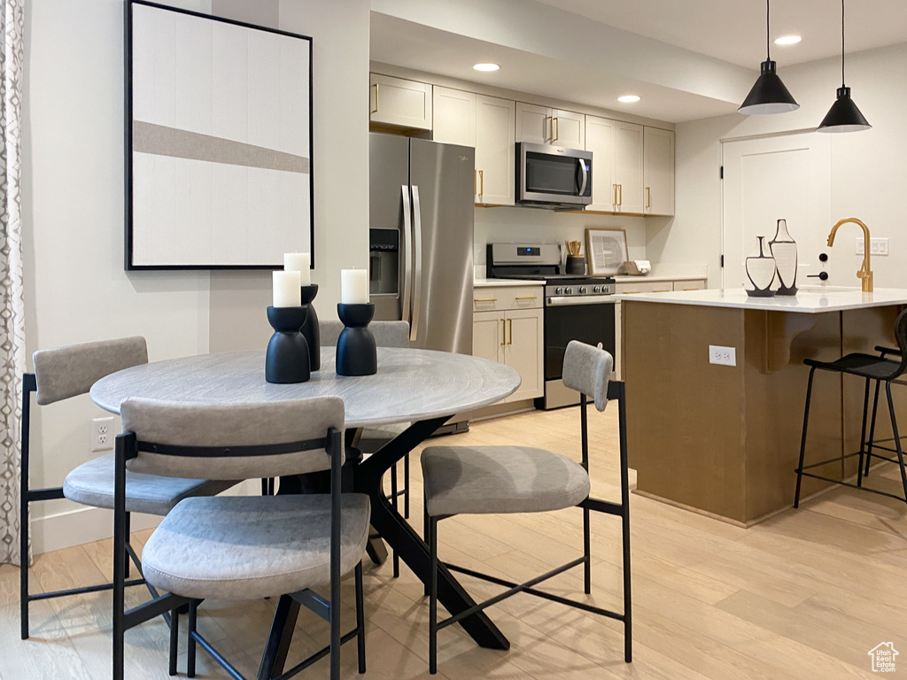 Kitchen featuring light countertops, light wood-type flooring, and appliances with stainless steel finishes