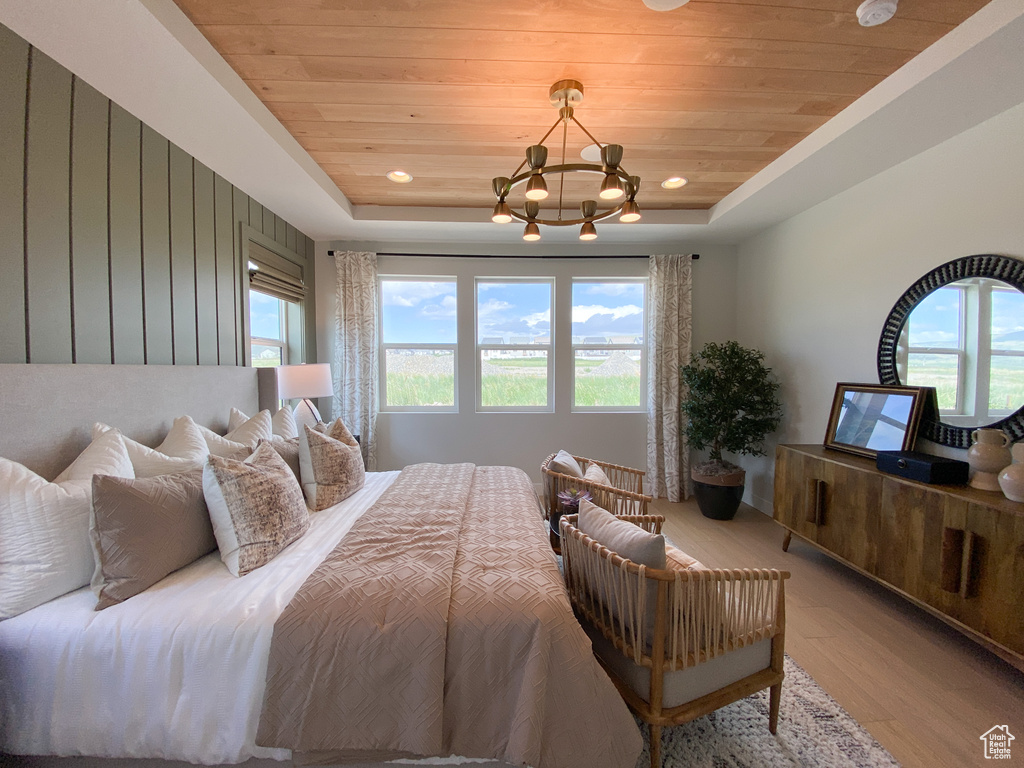 Bedroom with recessed lighting, a chandelier, wood finished floors, wood ceiling, and a raised ceiling