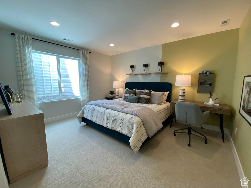 Bedroom featuring light colored carpet, baseboards, and recessed lighting