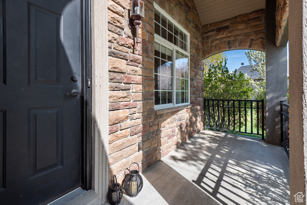 Property entrance featuring stone siding and covered porch