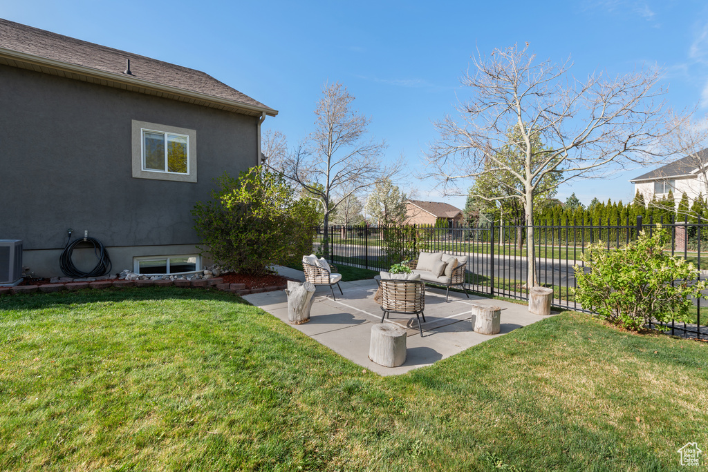 View of yard with fence and a patio area