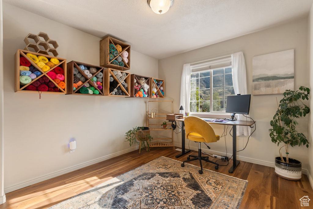 Home office featuring baseboards and wood finished floors