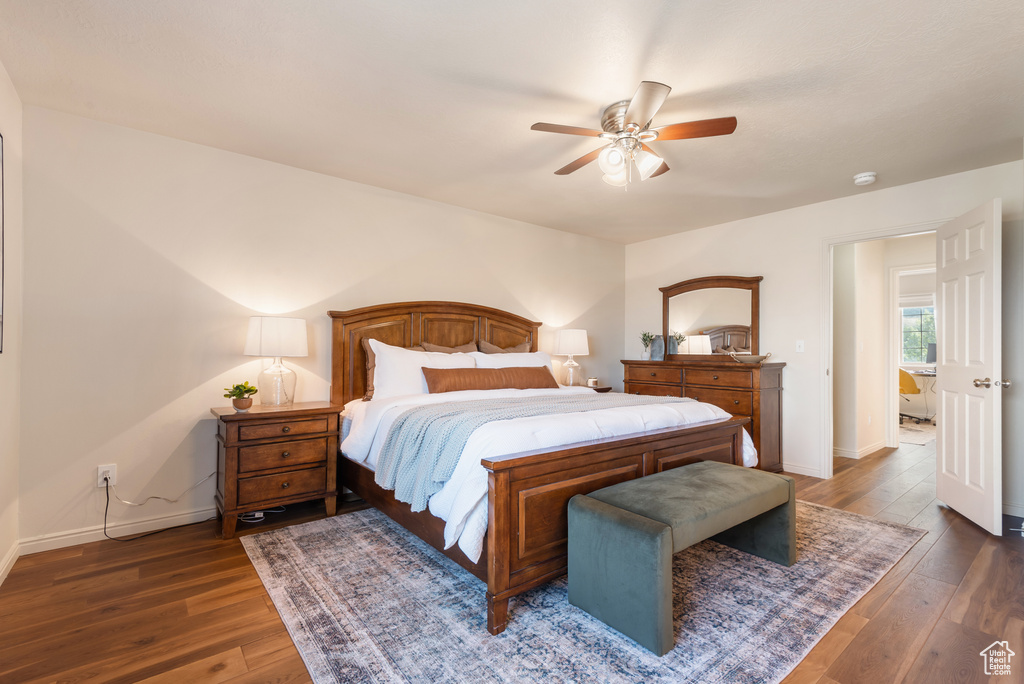 Bedroom featuring hardwood / wood-style flooring, baseboards, and a ceiling fan